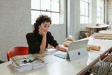 A picture of an entrepreneur in her studio working on her computer to grow her business with skills taught by Darren and Mike Dream Team